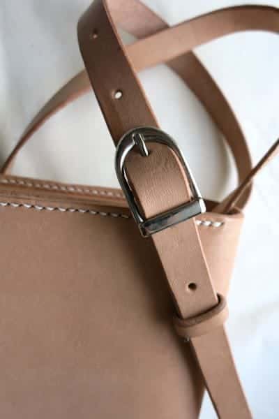 Buckle detail of small leather shoulder bag