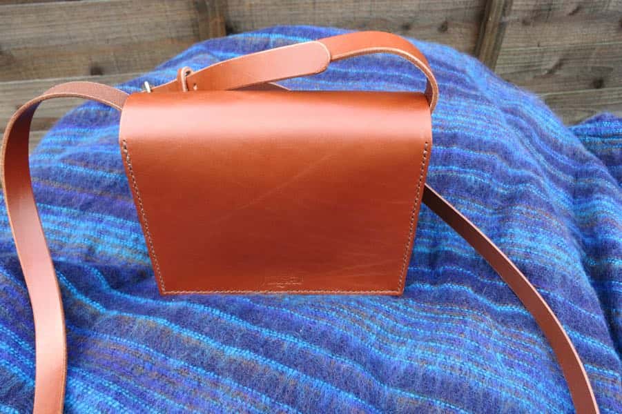 Back of small brown leather shoulder bag