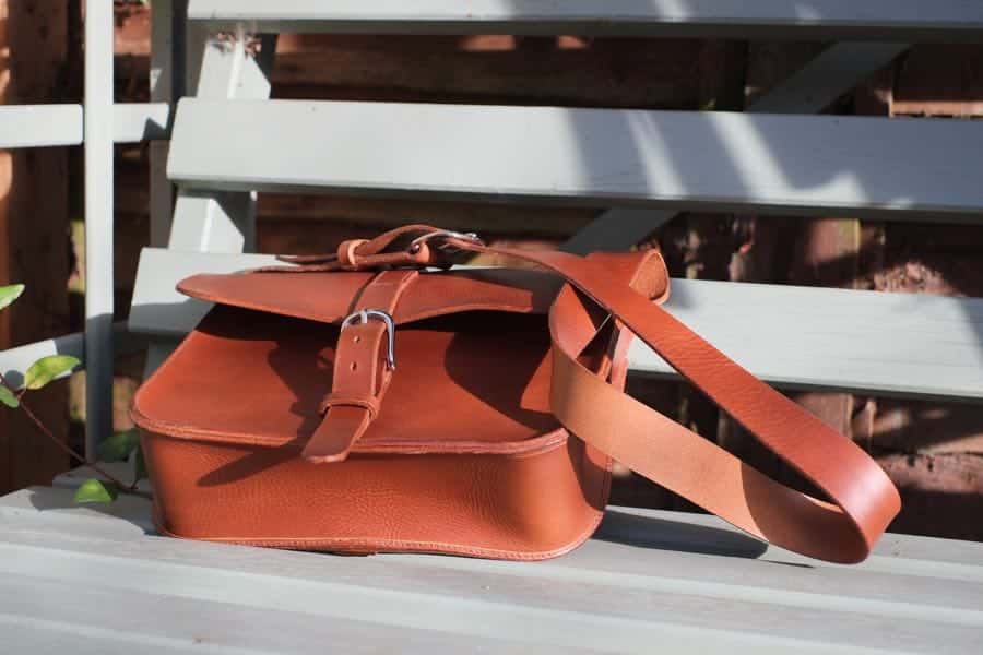 Large leather shoulder bag on bench