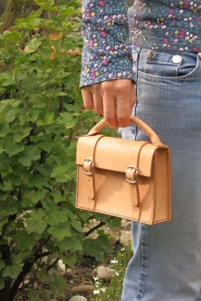 Mini satchel leather handbag being modelled