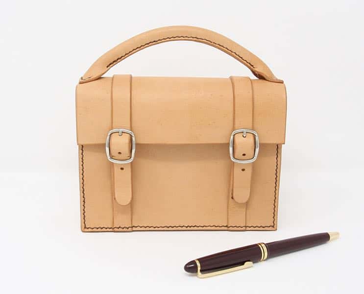 Mini satchel leather handbag with pen for scale