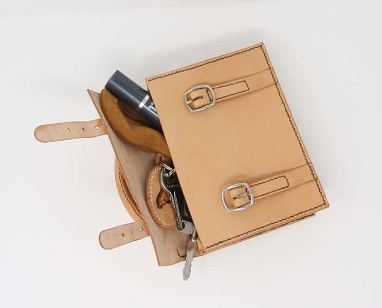 Mini satchel leather handbag open showing contents