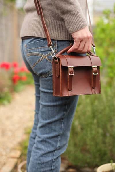 Mini satchel leather handbag being modelled