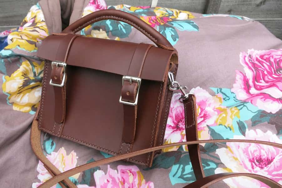 Mini satchel leather handbag on floral background