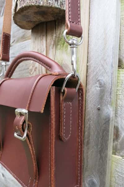 Mini satchel leather handbag showing strap fitting