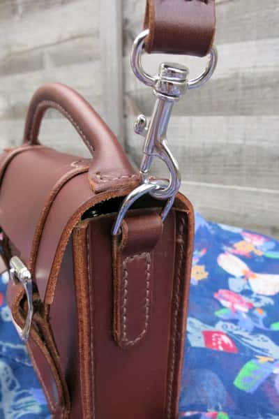 Mini satchel leather handbag showing strap fitting