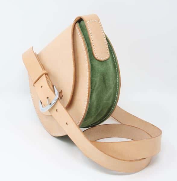 Side of round leather shoulder bag showing green gusset