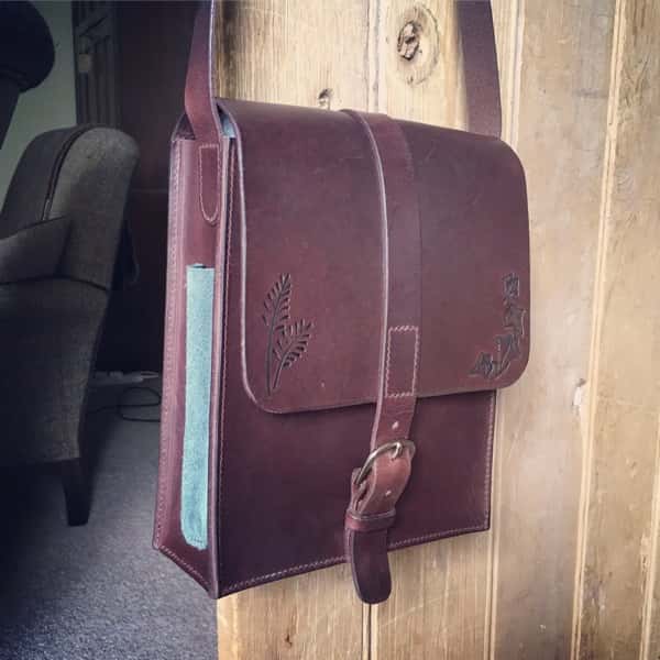 Chocolate coloured artist's sketch bag hanging on a door
