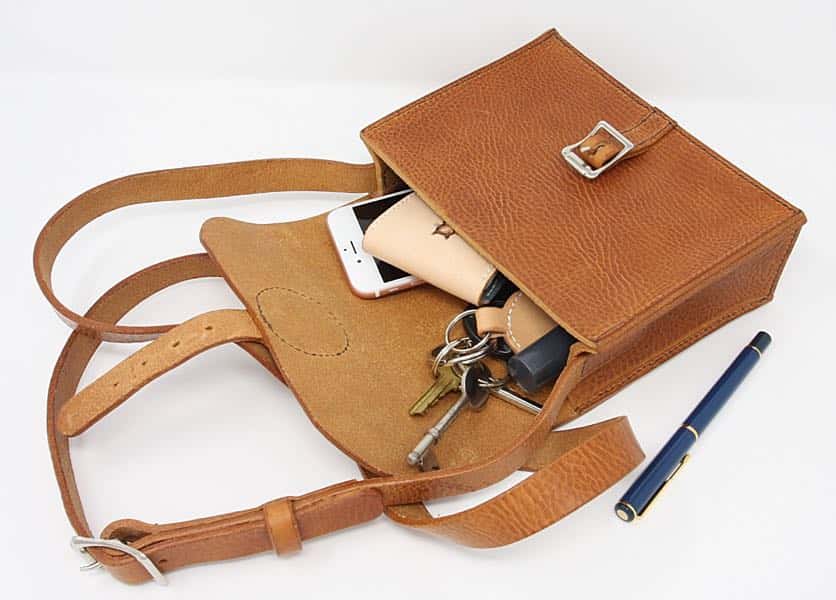 Tan brown medium leather shoulder bag open to show contents