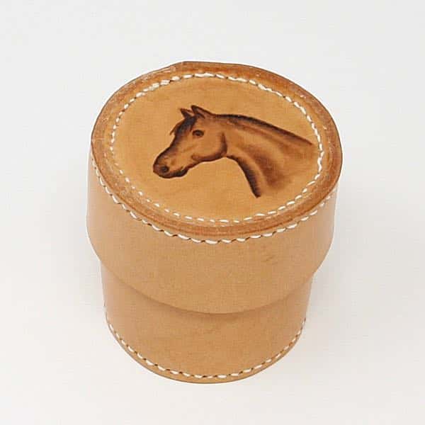 Small round leather box with horse head motif on white background