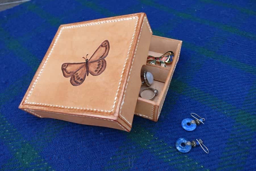 Shallow square leather box with earrings