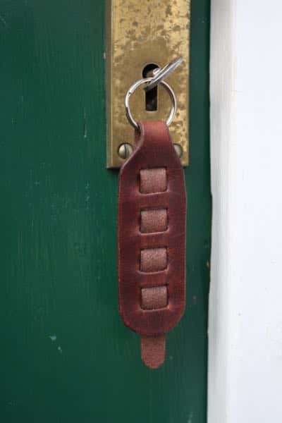 Woven leather key fob / key ring in a door