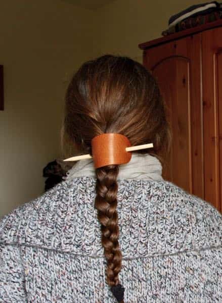 Tan leather hair barrette being worn