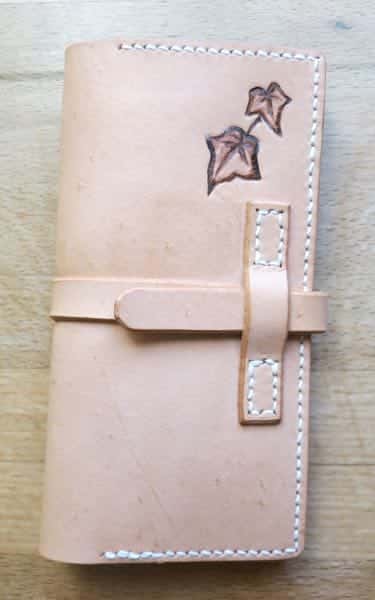 Front of leather phone case on wood background