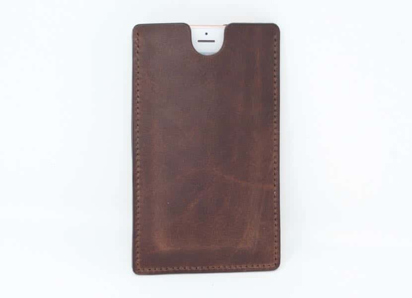 Brown leather phone sleeve holding an iPhone