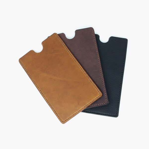 Three leather phone sleeves; tan, brown and black