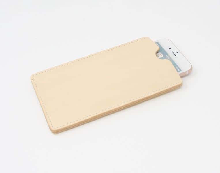 Cream leather phone sleeve holding an iPhone