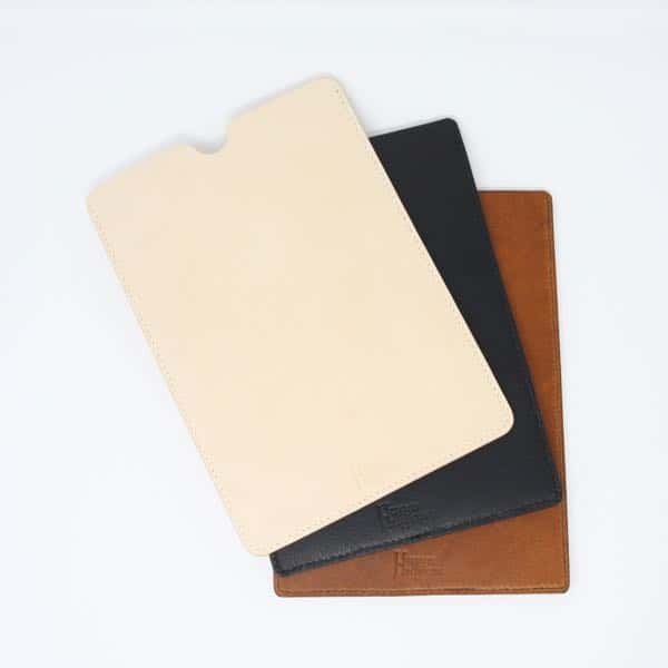 Three leather tablet sleeves; cream, black and brown
