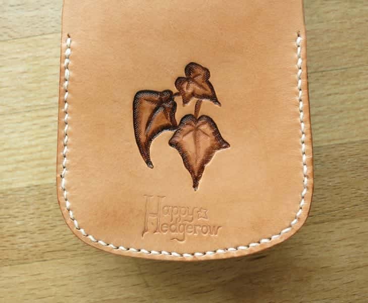 Back of large leather pouch showing motif
