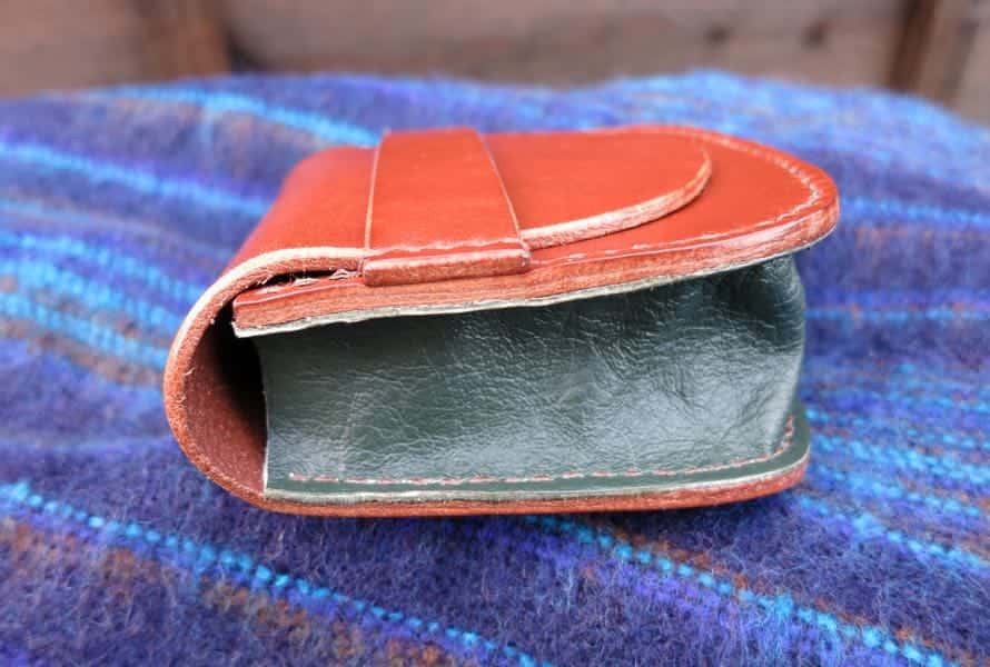 Side of large brown leather pouch showing green gusset