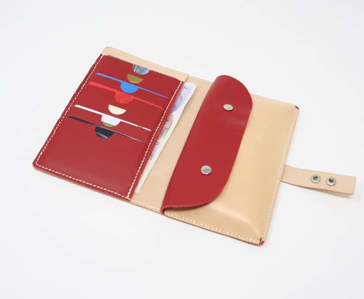 Natural leather wallet style purse with red interior shown open