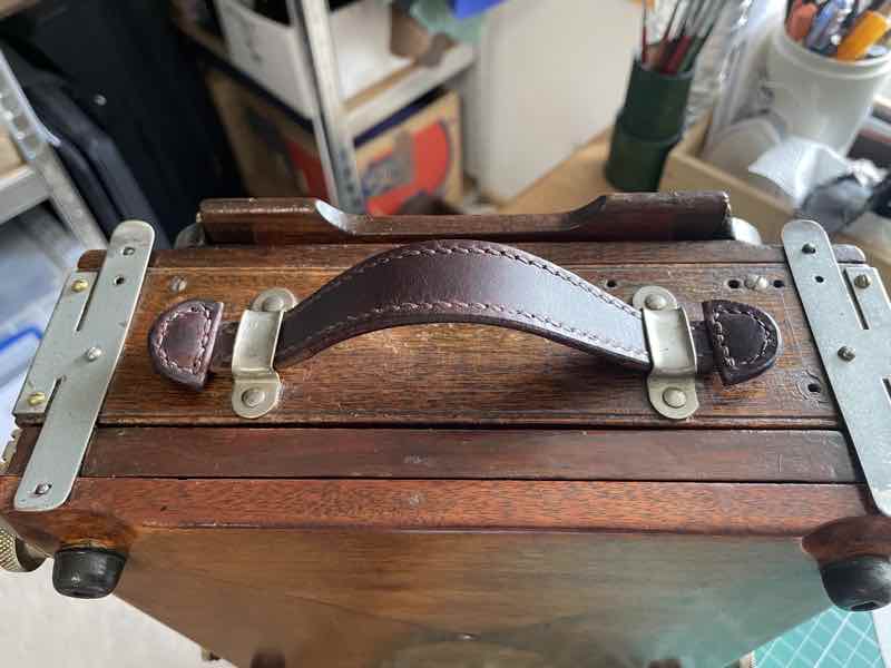 New leather handle on a wooden box camera